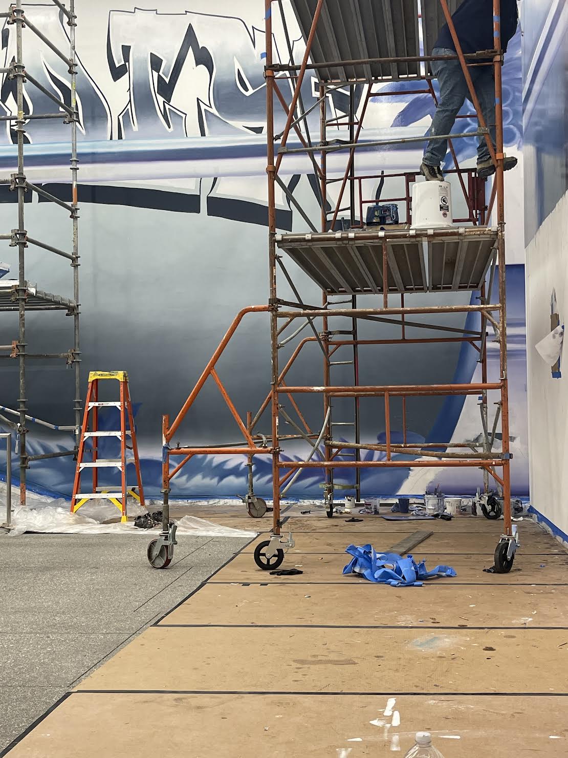 Hoist Media muralist painting Devin Reynolds mural at Hammer Museum