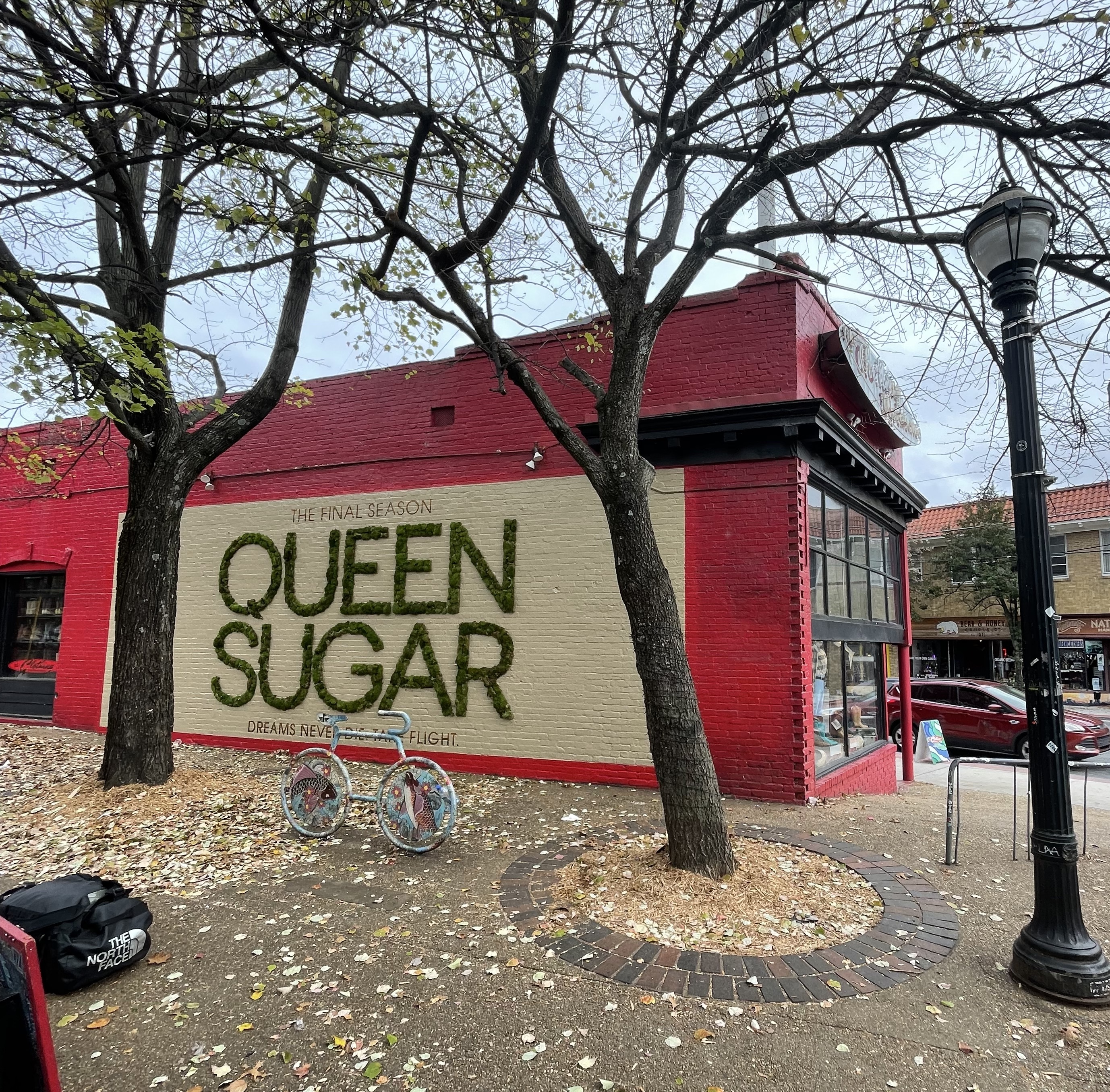 Queen Sugar living moss lettering on red brick building exterior in Atlanta