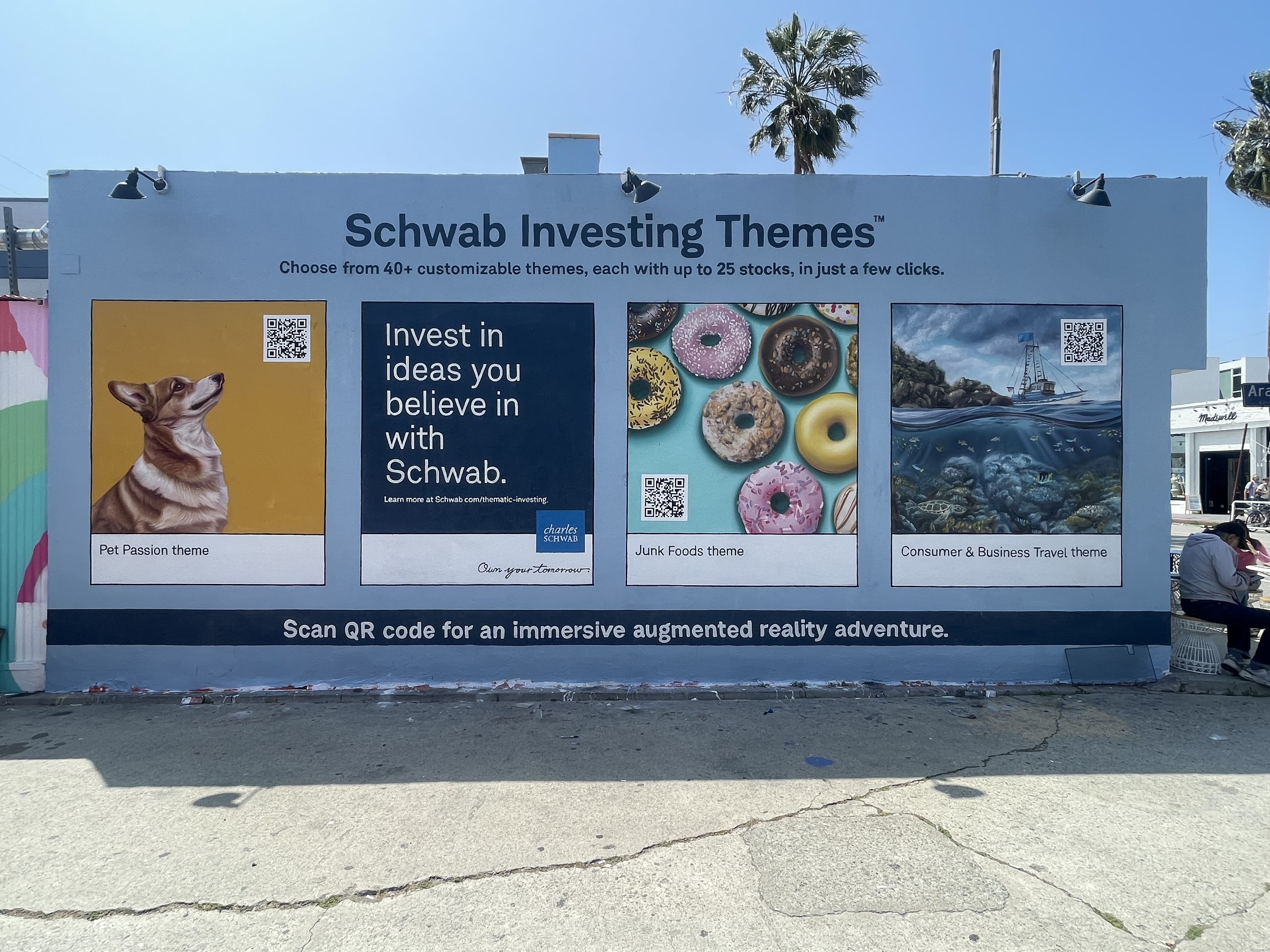 Completed Charles Schwab Investing Themes hand painted mural in Venice CA with corgi portrait donut and ocean panel illustrations