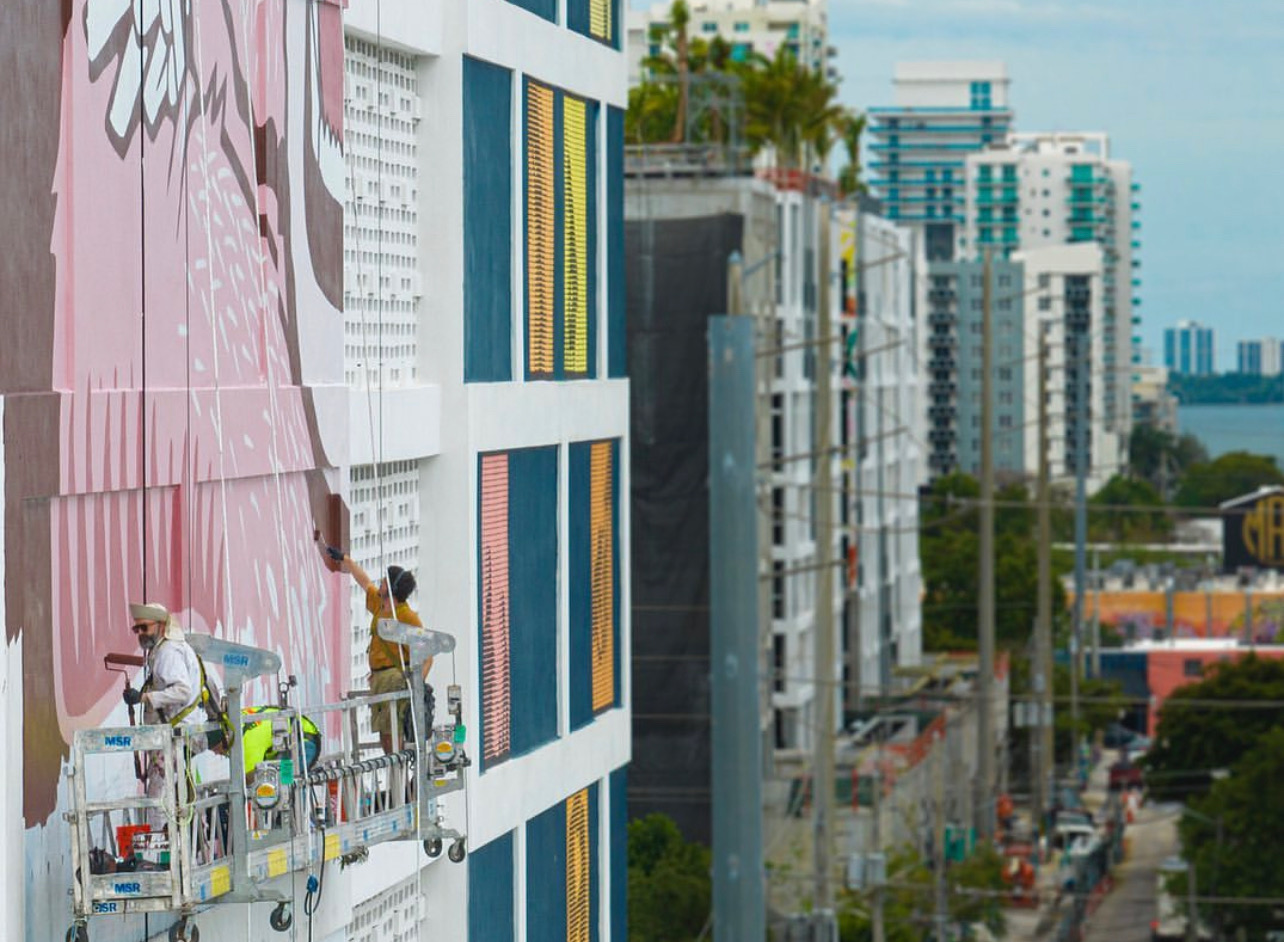 New Balance hand painted mural in Miami with Miami skyline in the background