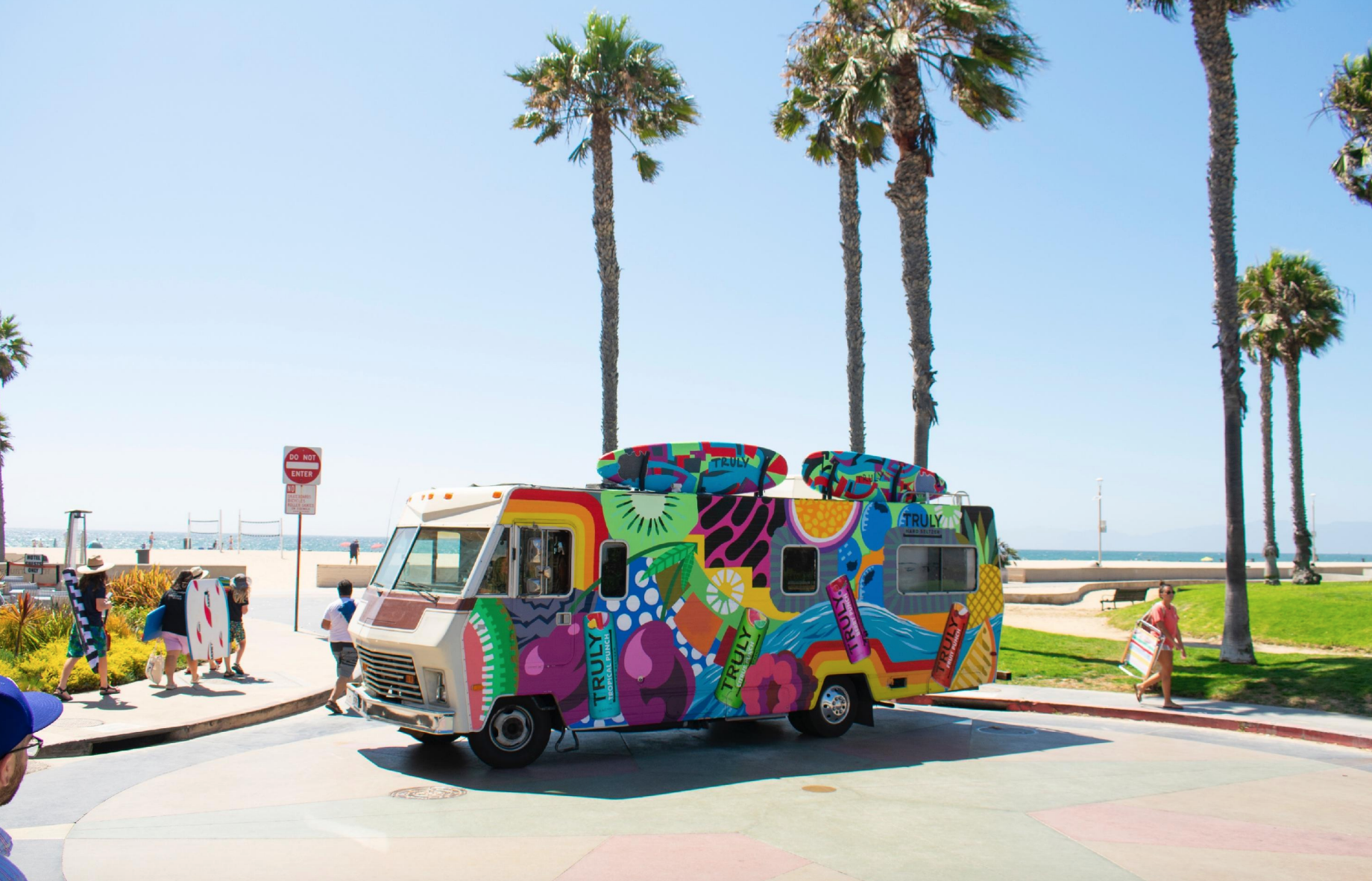 Truly Hard Seltzer painted Winnebago experiential activation at Venice Beach with palm trees and ocean
