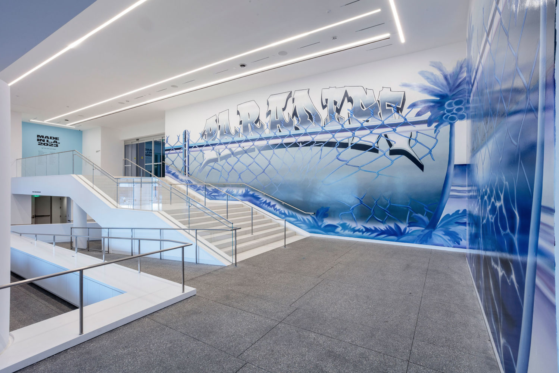 Hand painted mural spanning staircase and atrium wall at Hammer Museum Los Angeles